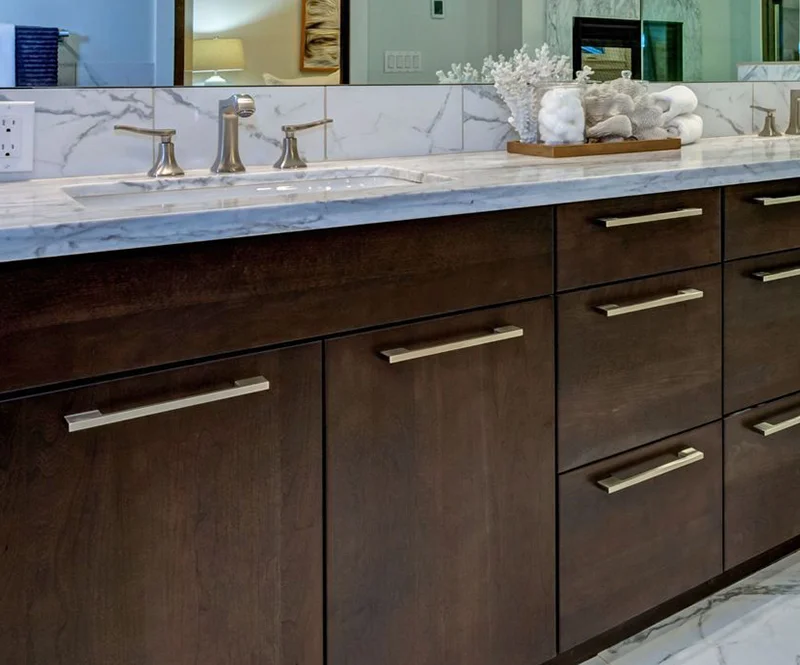 Dark Stained Wood Bathroom Vanity With Marble Countertops 800x665