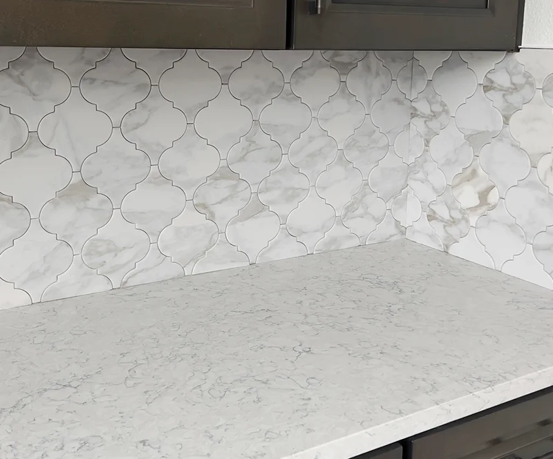 White Quartz Countertop And Arabesque Backsplash Tile